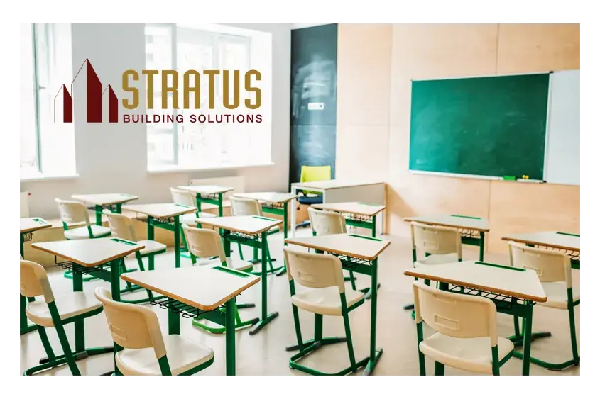 School classroom with desks and a chalkboard with the Stratus Logo